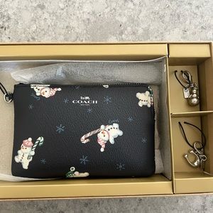 NWT. Coach snowman wristlet with charms. Original box included.